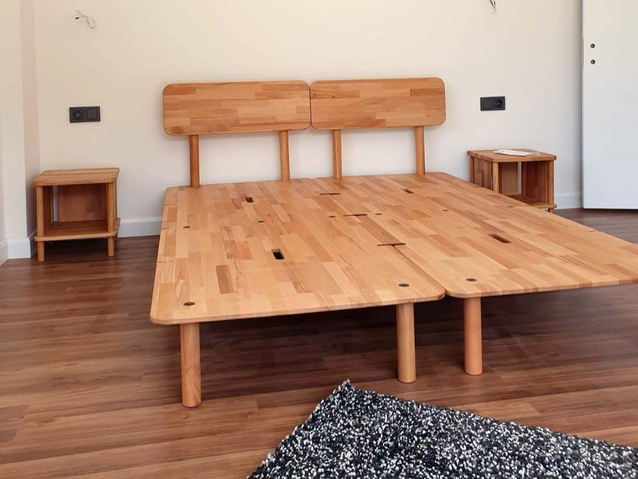 A solid beech bed frame in a quiet bedroom
