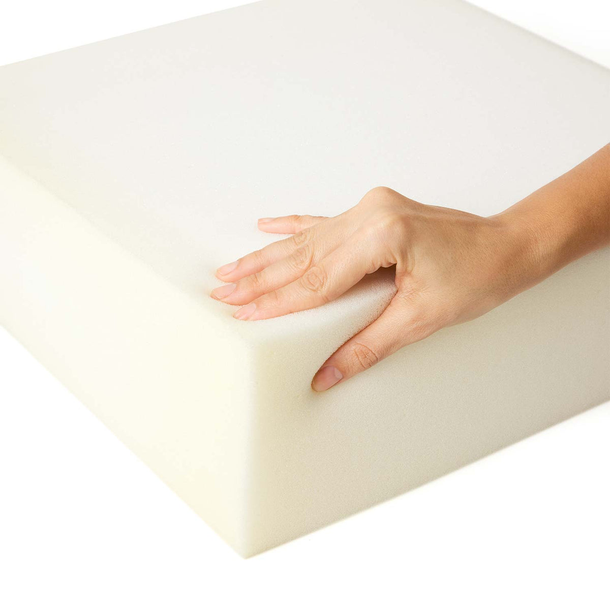 A hand pressing into a block of high-resilience foam