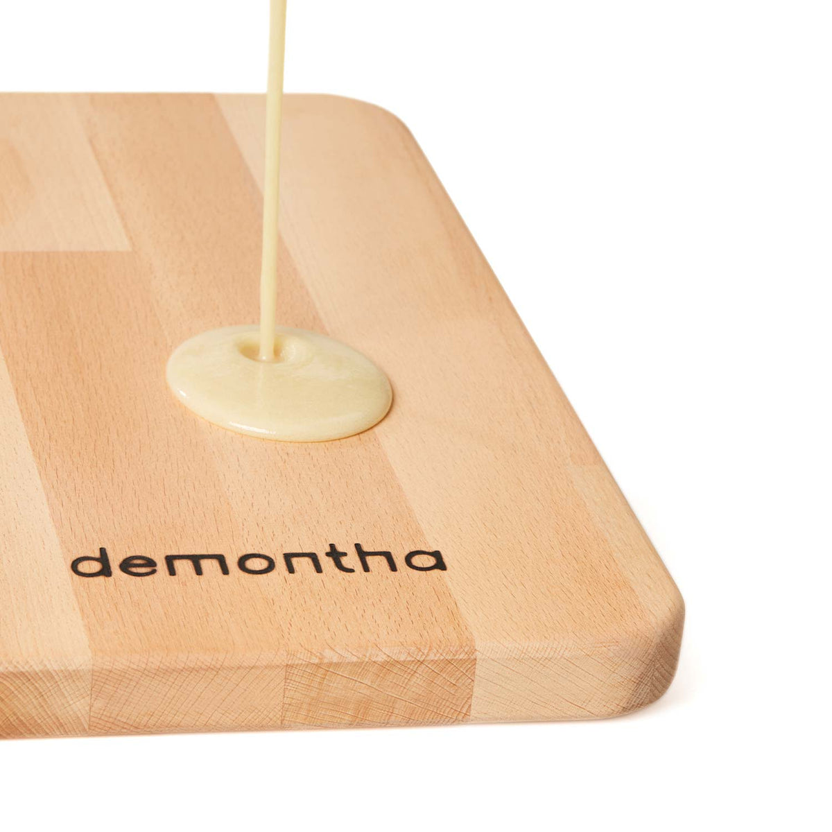 Natural wood oil poured onto a solid beech tabletop